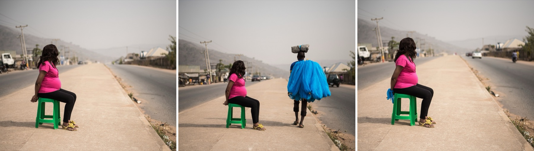 A triptych. In the outer panels a woman in a pink top sits on a low green stool at the edge of an empty road; in the centre she stands beside a figure in blue carrying a load on their head.
